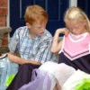 Saving Money On School Clothes - Two school age kids who are looking at their new school clothes.