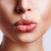 A pair of woman's lips with light pink lipstick