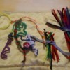 Stored pipe cleaners and some used for crafting shapes.