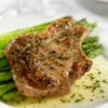 Seasoned pork chop on asparagus