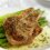 Seasoned pork chop on asparagus