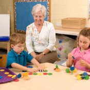 A grandma teach two younger children.