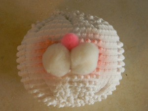 Adding white pom pom cheeks and pink nose.