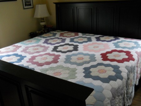 Flower Garden Quilt on bed.