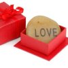 A rock engraved with the word love.