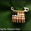 A safety pin with beads in a flag pattern.