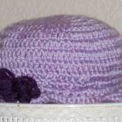 A purple crocheted hat for a toddler.