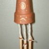 Wind chimes that are made from a clay pot.