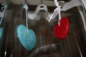 Air fresheners hanging from shower curtain rings.