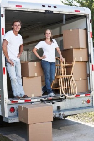 A couple loading a moving truck.