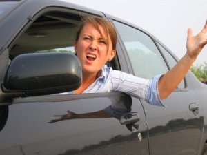 Photo of a lady yelling at a driver.