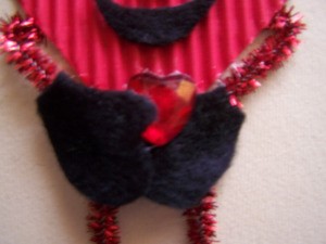 Gluing red rhinestone in place.