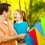 Father and daughter holding a kite.