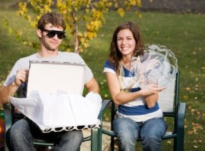 A couple opening wedding gifts.
