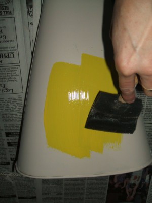 Painting the primed bucket yellow.