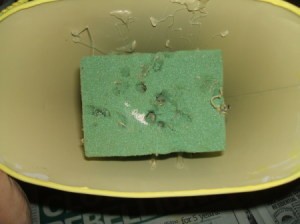 Floral foam at base of bucket.