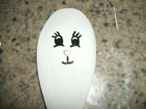 Tracing over pencil facial lines with marker.