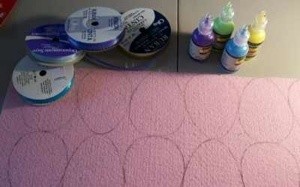 Supplies and eggs drawn  on felt.