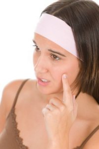 girl looking at a pimple
