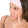 girl looking at a pimple