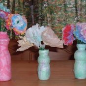 Drinkable yogurt bottle vases with paper flowers.