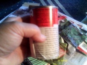 Newspaper wrapped around a tomato paste can.