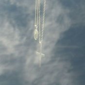 Unexpected photo op, clouds reflected on windshield behind cross.