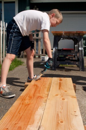 Boy Helping Stain Panels