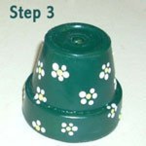 Finished clay pot with painted flowers.