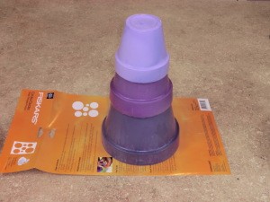 Stack of painted flower pots for base.
