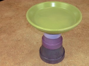 Large flower pot saucer glued to base.