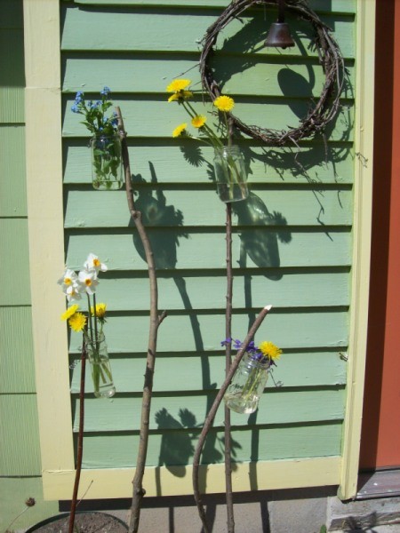 Recycled jar garden vases by the house.