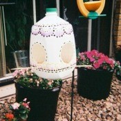 Milk jug bird feeder on patio