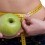 Woman Measuring Her Waist Holding Apple