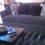Dark gray couch and black rug.