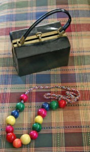 String of beads and plastic box purse.