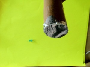 Aluminum foil at the end of the tube has been pricked with pushpin.