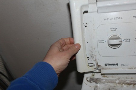 Removing plastic end cap from washing machine control panel