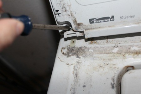 Removing screws from washing machine control panel