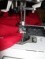 Closeup of Brother sewing machine needle.