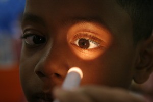Examining a child's eyes.
