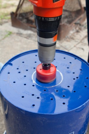 Drilling Wick Hole in Bottom of Bucket