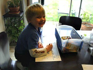 A preschooler working on his letter of the day