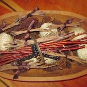 Pine needle bundles in wooden bowl with other nature decorations, such as pine cones, etc.