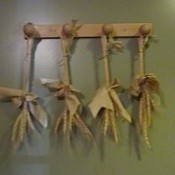 Tied stalks hanging from pegs.