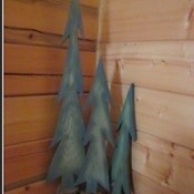 Painted trees standing in corner.