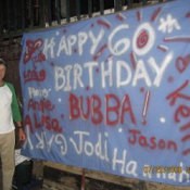 Blue sheet with birthday wishes painted on it.