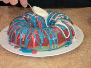 Drizzling frosting onto cake.