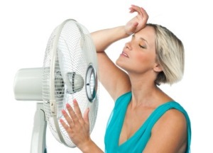 Woman Cooling Off in Front of Fan