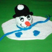 Snowman's head on a melted puddle of white crochet.